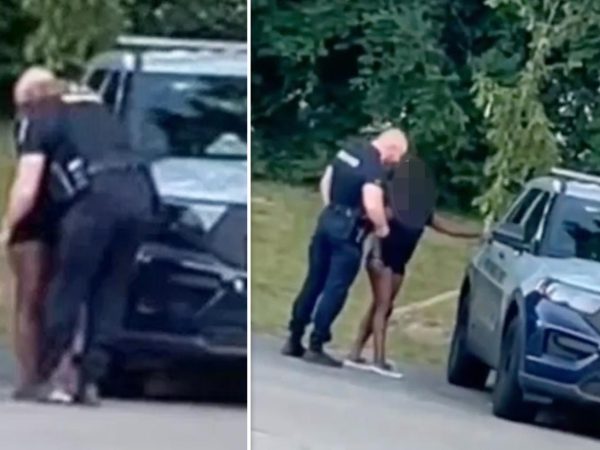 US police suspend officer caught in viral video kissing scantily clad woman before climbing into back of squad car with her (video)