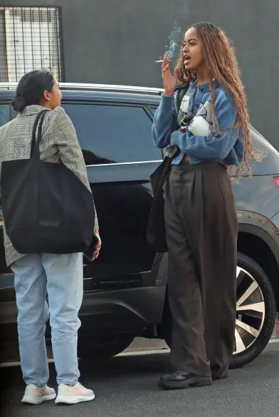 Malia Obama seen smoking in public weeks after younger sister Sasha was pictured smoking