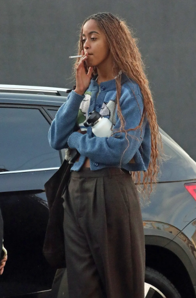 Malia Obama seen smoking in public weeks after younger sister Sasha was pictured smoking