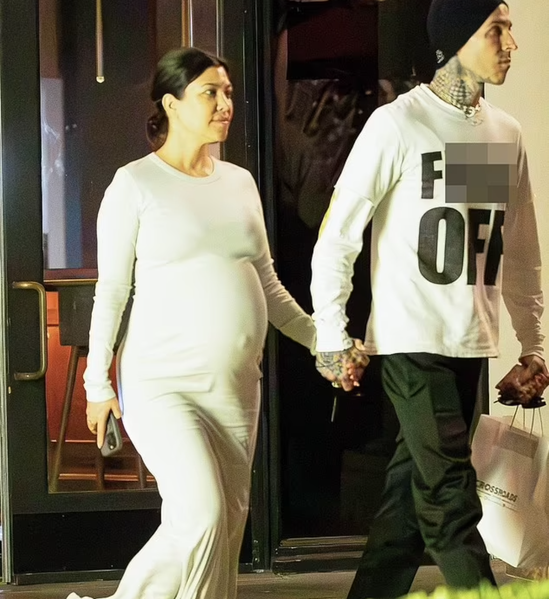 Kourtney Kardashian shows off her huge baby bump while holding hands with Travis Barker after vegan dinner date (photos)