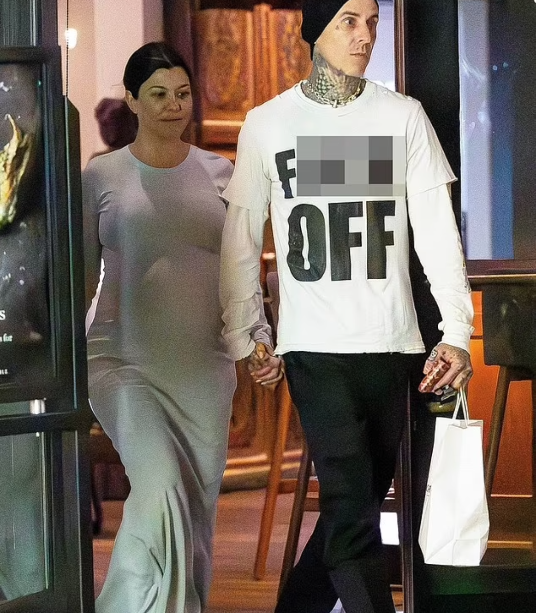 Kourtney Kardashian shows off her huge baby bump while holding hands with Travis Barker after vegan dinner date (photos)