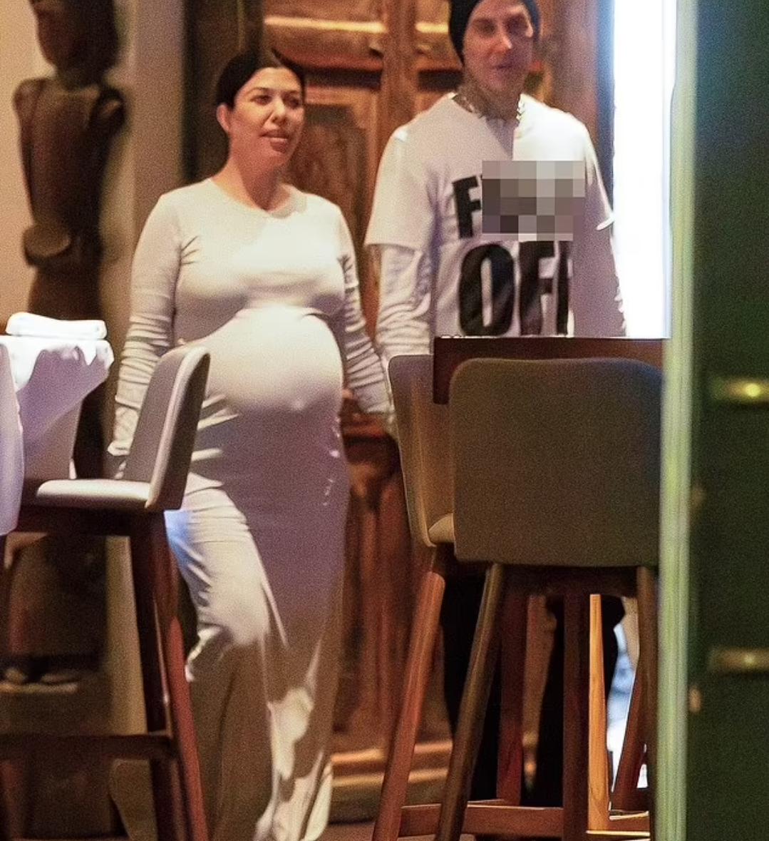 Kourtney Kardashian shows off her huge baby bump while holding hands with Travis Barker after vegan dinner date (photos)
