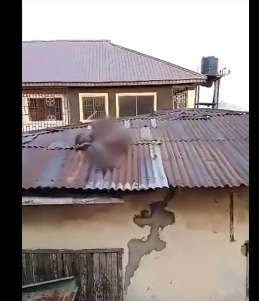 VIDEO: N@ked person creates a scene after being spotted on a roof in Benin