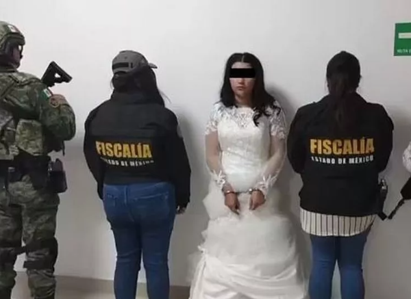 Bride is handcuffed and her mugshot taken in wedding dress before tying knot with cartel ‘mouse’