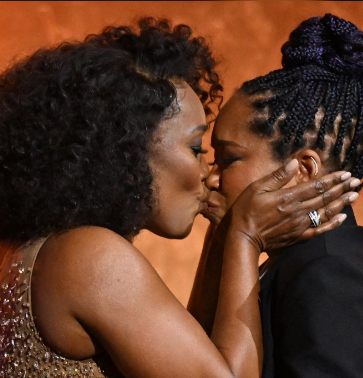 Angela Bassett and Regina King share a kiss at the Governors Awards