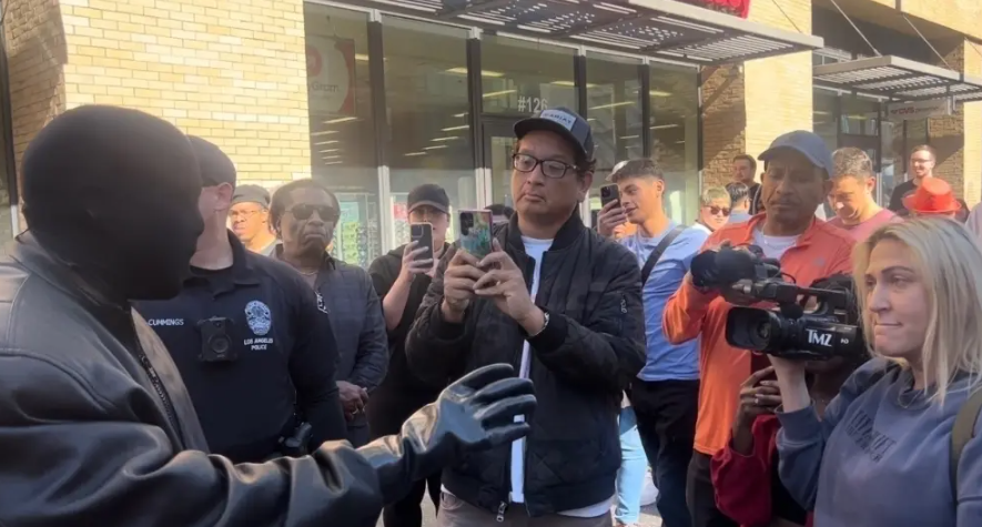 Kanye West grabs phone from paparazzi who asked if he is controlling his wife (video)