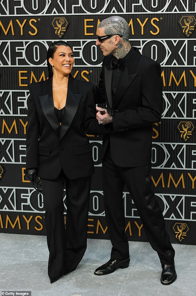 Kourtney Kardashian and Travis Barker share a passionate kiss at the Emmy Awards as she attends first public event since welcoming their first child (photos)