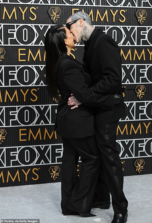 Kourtney Kardashian and Travis Barker share a passionate kiss at the Emmy Awards as she attends first public event since welcoming their first child (photos)