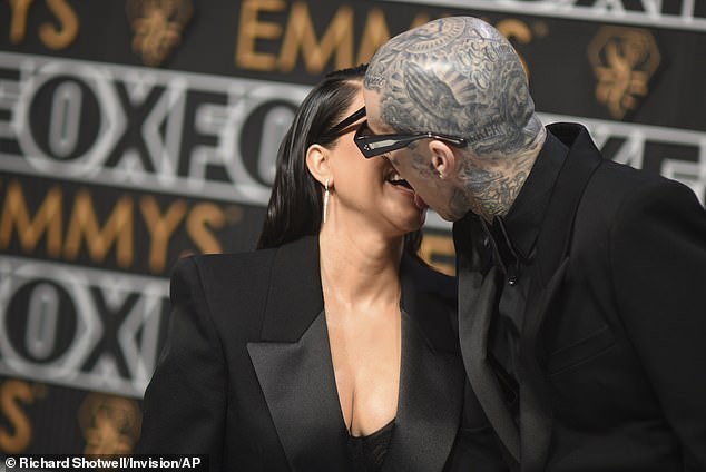 Kourtney Kardashian and Travis Barker share a passionate kiss at the Emmy Awards as she attends first public event since welcoming their first child (photos)