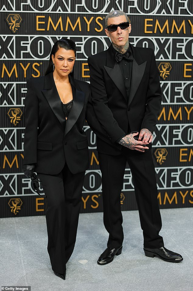 Kourtney Kardashian and Travis Barker share a passionate kiss at the Emmy Awards as she attends first public event since welcoming their first child (photos)