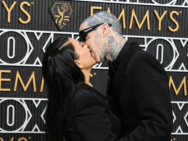 Kourtney Kardashian and Travis Barker share a passionate kiss at the Emmy Awards as she attends first public event since welcoming their first child (photos)