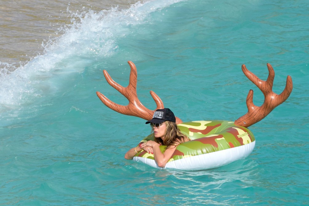 50-year-old Heidi Klum goes topless in just bikini as she makes out with husband on the beach (photos)