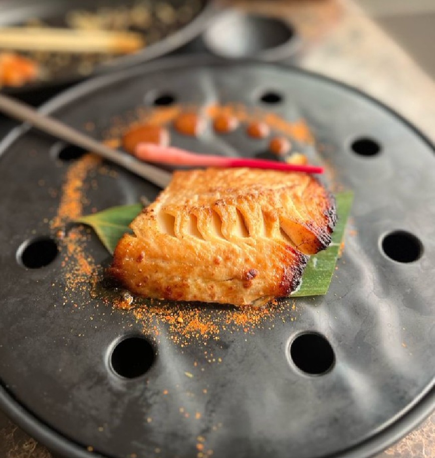 Customers show the size of fish they were charged N87k for at a Japanese restaurant in Lagos