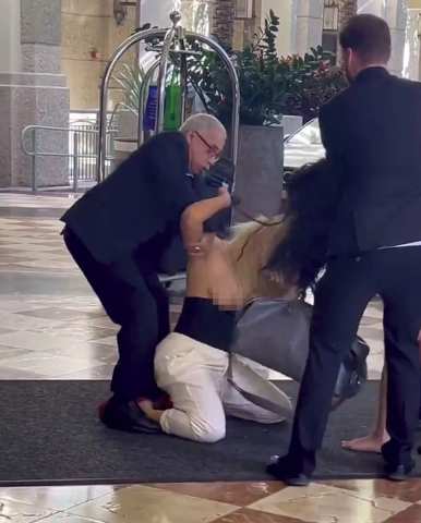 Boobs fly out as two women fight in a hotel lobby (video)