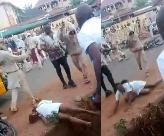 Outrage as masquerades brutally flog female nurse until she falls in a gutter in Enugu (video)