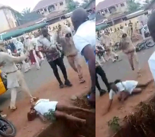 Outrage as masquerades brutally flog female nurse until she falls in a gutter in Enugu (video)