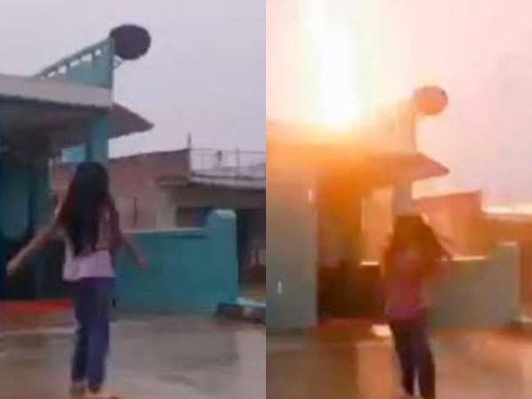 Girl dancing in rain narrowly escapes being struck by lightning (video)