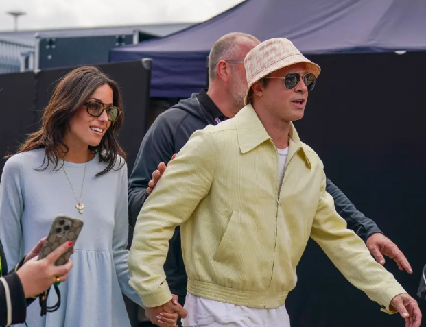 Brad Pitt and girlfriend Ines de Ramon hold hands at British Grand Prix in rare public outing