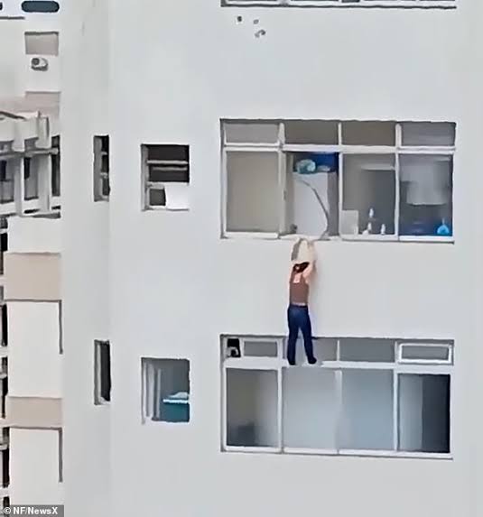 Cleaner left dangling from 16th-floor window after she slipped while cleaning (video)